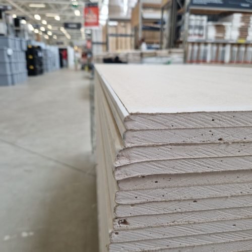 Close-up of drywall sheets stacked in a large warehouse in London.